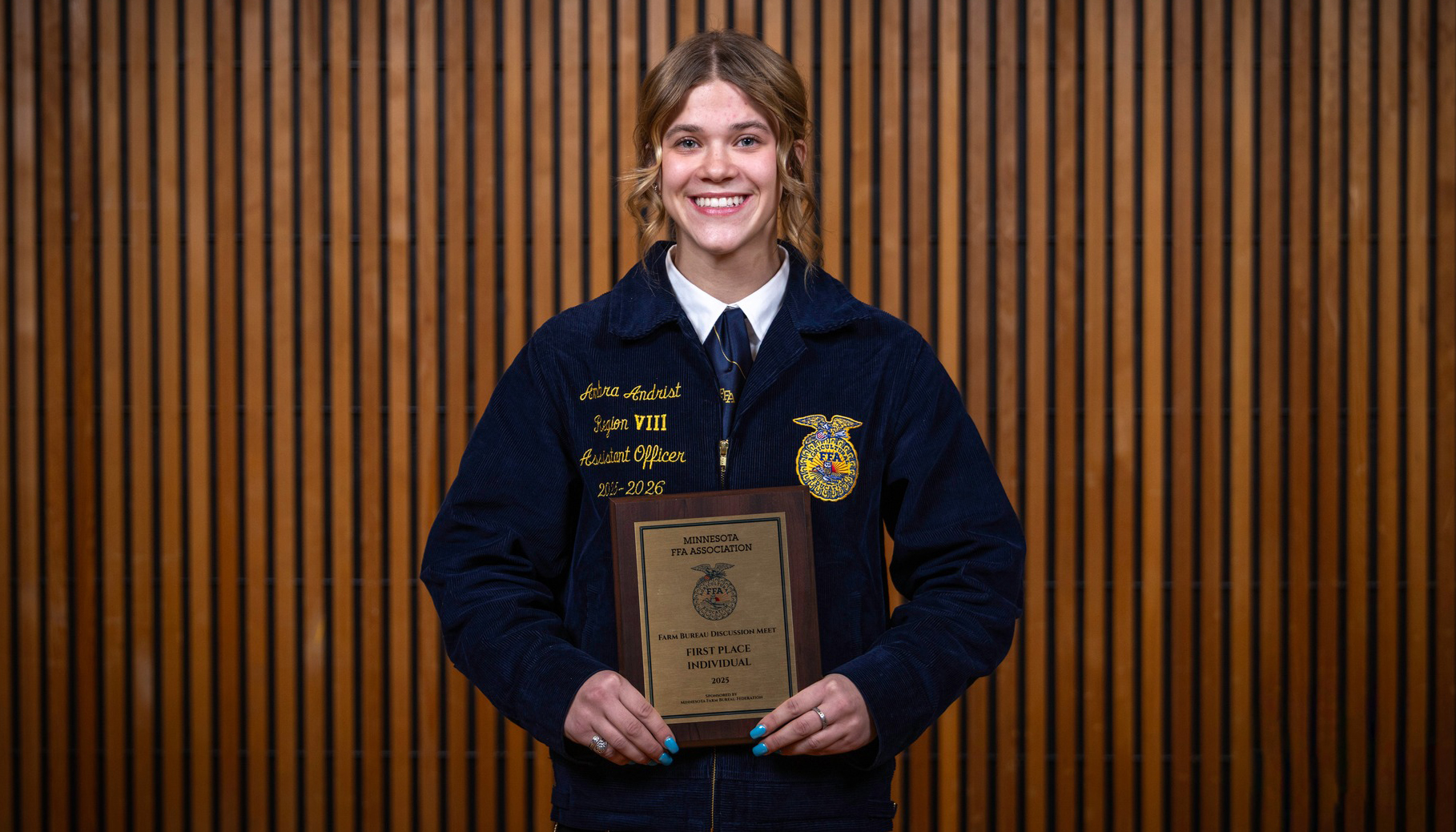 woman standing holding a plaque